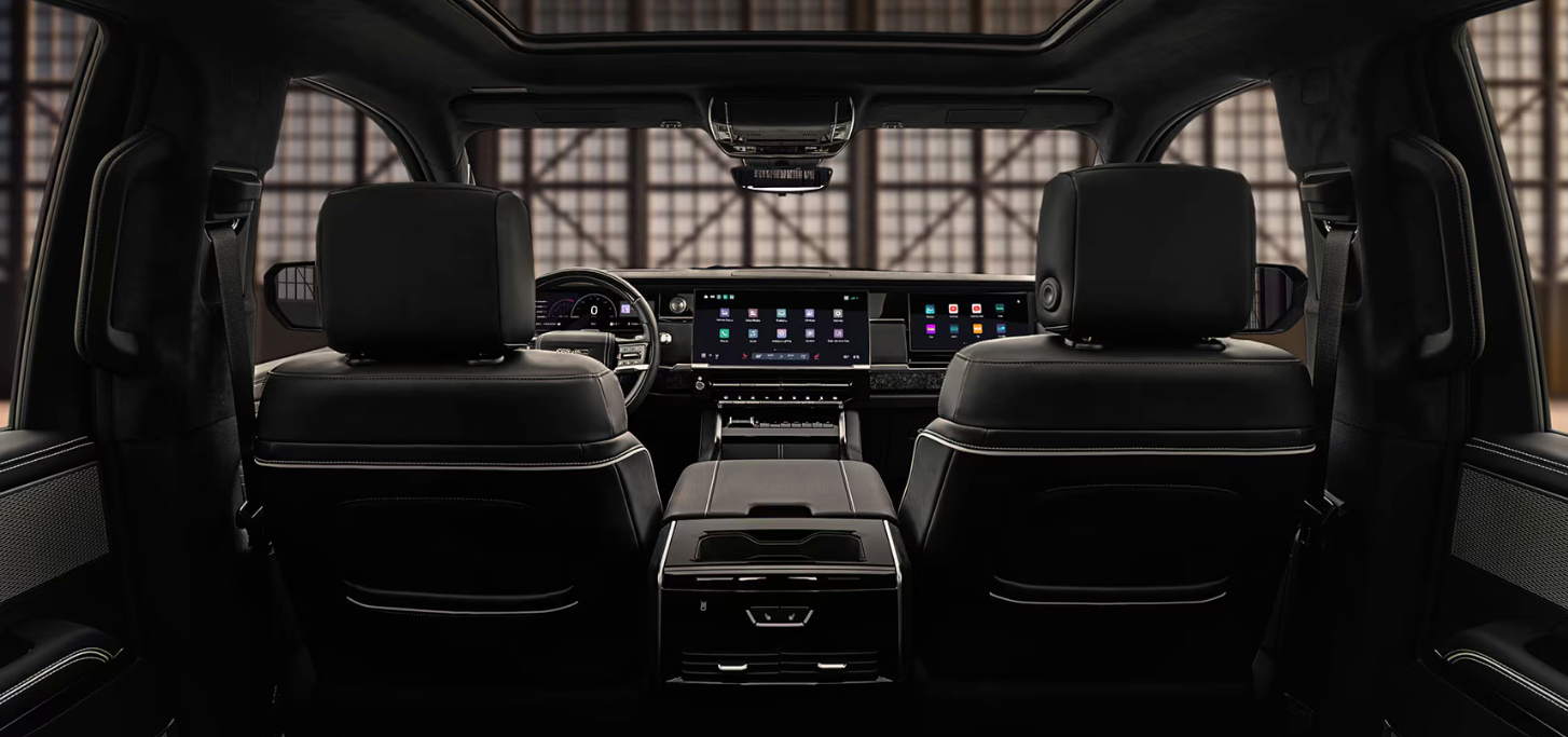2027 GMC Sierra 1500 Denali Ultimate interior showing massaging front seats, Head-Up Display and front passenger screen