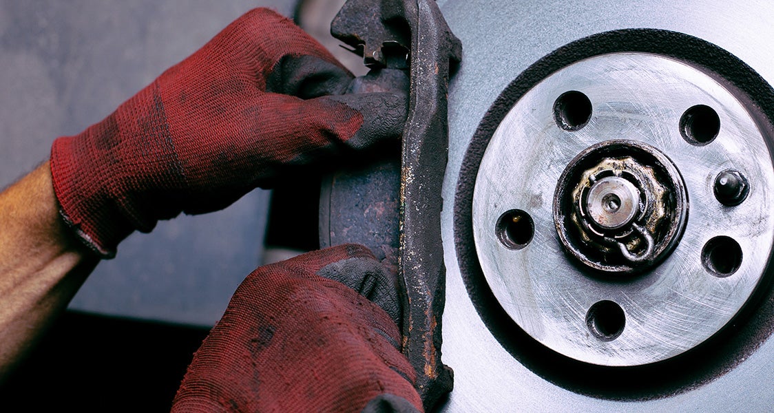 Certified Buick technician performing a multi-point vehicle inspection at Cable Dahmer Buick GMC